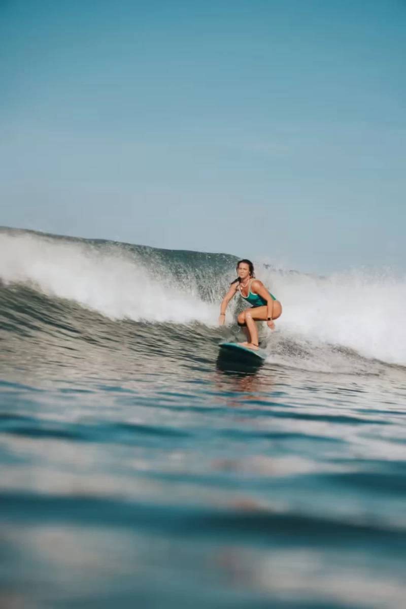 Surfen bis zum Sonnenuntergang in den Wellen Uluwatus